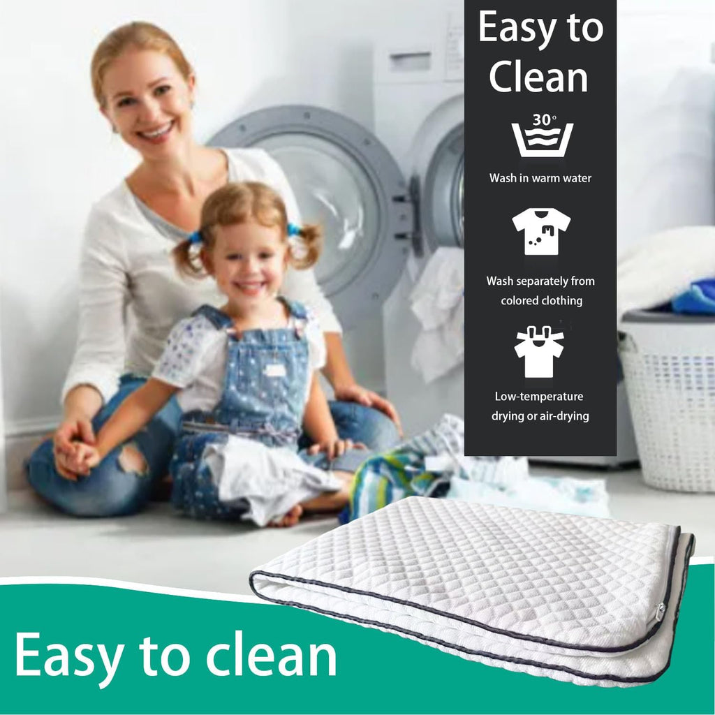 A quilted white mattress topper with a dark gray border is shown in the foreground, with a woman and child sitting in front of a washing machine in the background. Text overlays read 'Easy to Clean' with icons indicating wash and dry care instructions.
